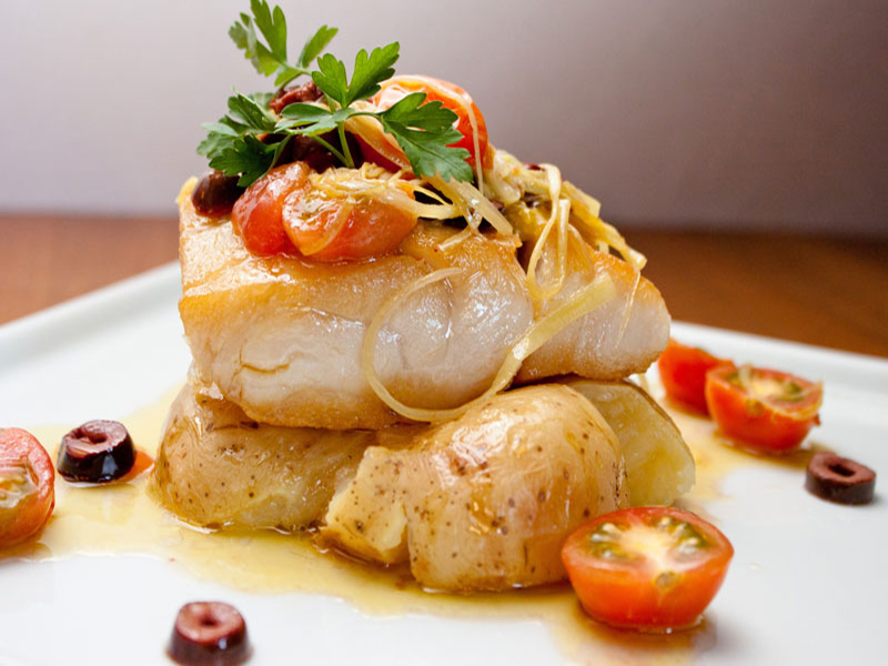classy image of cod with tomato and cilantro garnish